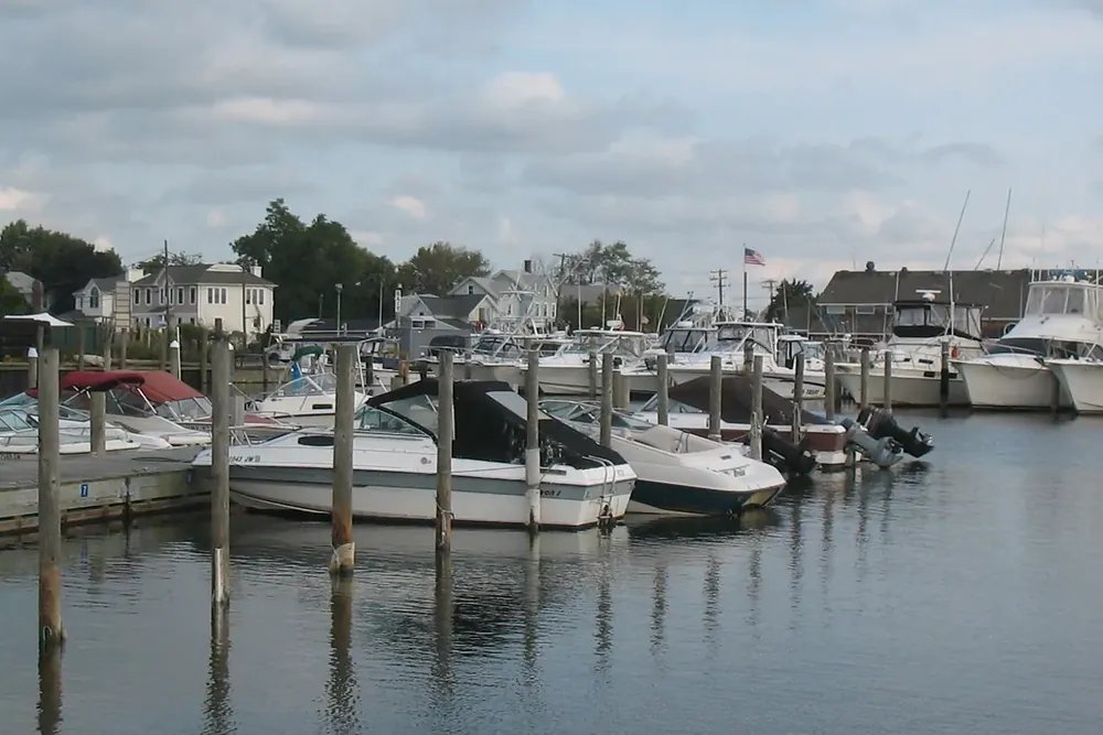 Small boats moored at a marina on the water in Bay Shore, New York