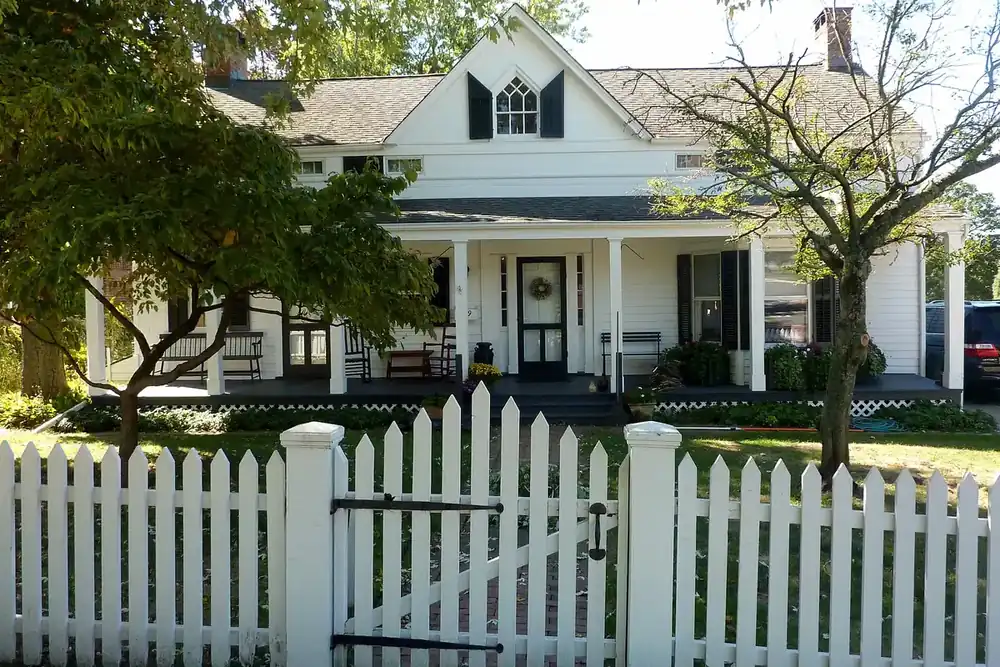 Isaac Losee House, a white historic home behind a picket fence in Huntington, New York