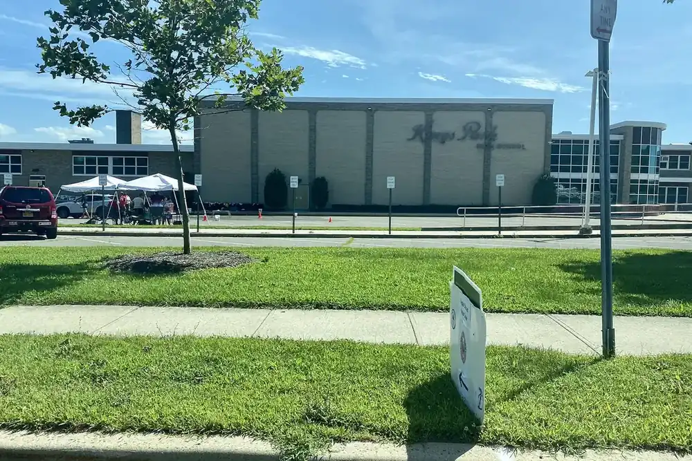 Kings Park High School building with a lawn and sidewalk in Kings Park, New York